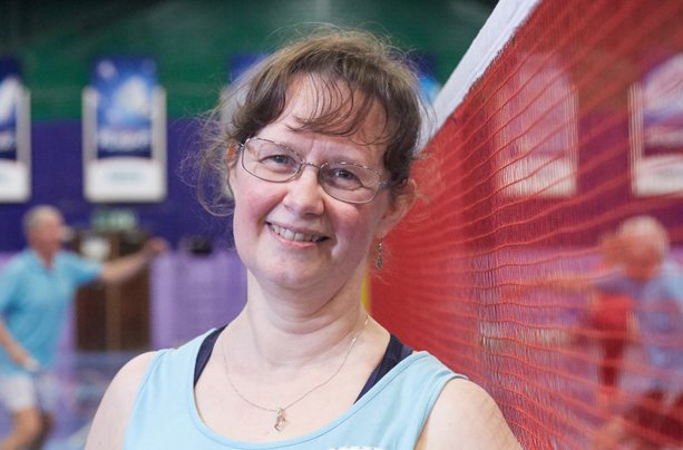 Woman at a sports centre, taking a break from playing badminton